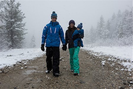 Full length of happy parents with son walking on road during winter Stock Photo - Premium Royalty-Free, Code: 6109-08945307