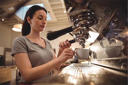 Young female barista making espresso in coffee shop Stock Photo - Premium Royalty-Free, Code: 6109-08945430