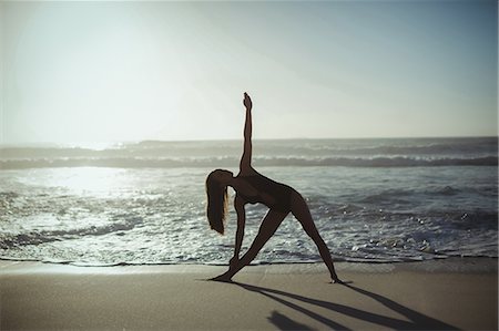 simsearch:6128-08825413,k - Woman performing yoga on beach Stock Photo - Premium Royalty-Free, Code: 6109-08952979
