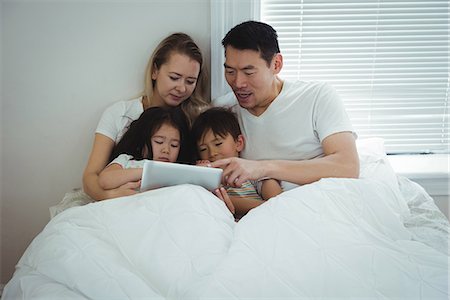 simsearch:400-05119279,k - Family using digital tablet in bedroom Stock Photo - Premium Royalty-Free, Code: 6109-08953092