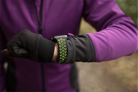 physical - Mid section of woman using smart watch in the forest Stock Photo - Premium Royalty-Free, Code: 6109-08953855