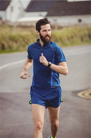 simsearch:400-04535435,k - Handsome athlete running on the road Stock Photo - Premium Royalty-Free, Code: 6109-08928483