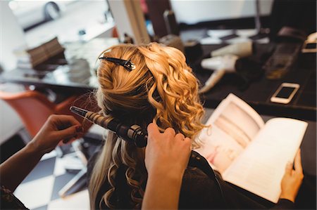 simsearch:693-06022101,k - Female hairdresser styling clients hair in saloon Stock Photo - Premium Royalty-Free, Code: 6109-08928417