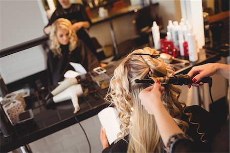 simsearch:693-06022101,k - Female hairdresser styling clients hair in saloon Stock Photo - Premium Royalty-Free, Code: 6109-08928419