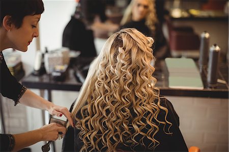 simsearch:6118-08660009,k - Female hairdresser styling clients hair in saloon Stock Photo - Premium Royalty-Free, Code: 6109-08928427