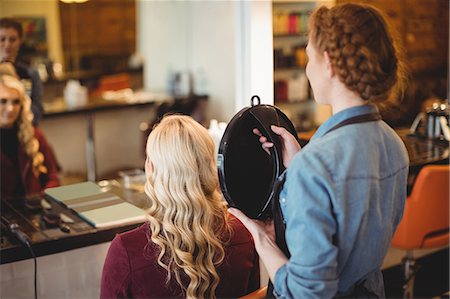 simsearch:6118-08660009,k - Female hairdresser styling clients hair in saloon Stock Photo - Premium Royalty-Free, Code: 6109-08928432