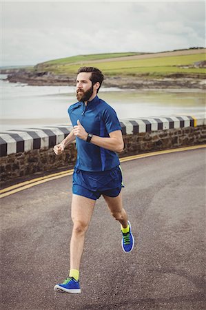 simsearch:400-04535435,k - Handsome athlete running on the road Stock Photo - Premium Royalty-Free, Code: 6109-08928503