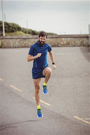 simsearch:628-05817723,k - Handsome athlete running on the road Stock Photo - Premium Royalty-Free, Code: 6109-08928500