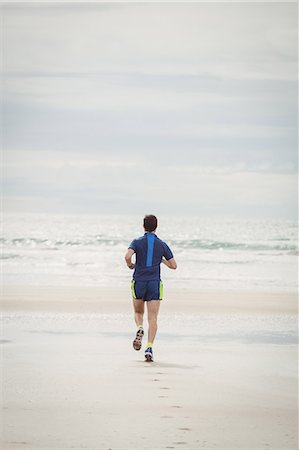 simsearch:693-07672615,k - Rear view of athlete running on the beach Stock Photo - Premium Royalty-Free, Code: 6109-08928513