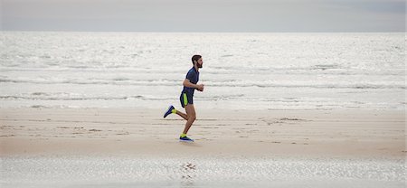 simsearch:400-04535435,k - Handsome athlete running along the beach Stock Photo - Premium Royalty-Free, Code: 6109-08928514