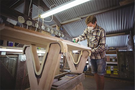 Man using modified planer in the surfboard workshop Stock Photo - Premium Royalty-Free, Code: 6109-08929117