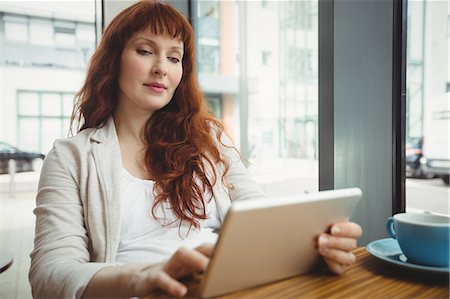 simsearch:6109-08700445,k - Pregnant businesswoman using digital tablet in office cafeteria Stock Photo - Premium Royalty-Free, Code: 6109-08929298