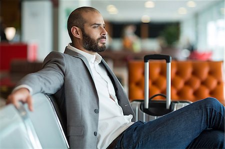 simsearch:400-03938985,k - Thoughtful businessman sitting on chair in waiting area at the airport terminal Foto de stock - Sin royalties Premium, Código: 6109-08929438