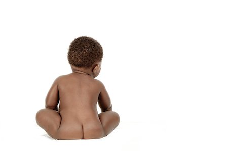 Shot from behind of an infant sitting in front of a white background Stock Photo - Premium Royalty-Free, Code: 6110-06702755