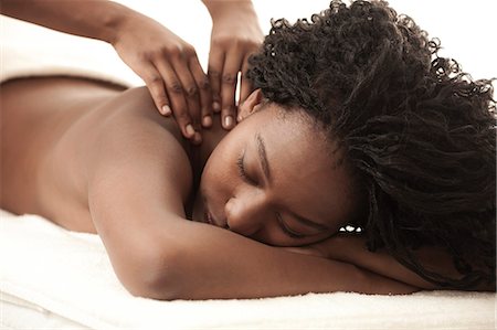 Young black woman in a salon receiving a back massage Stock Photo - Premium Royalty-Free, Code: 6110-06702707