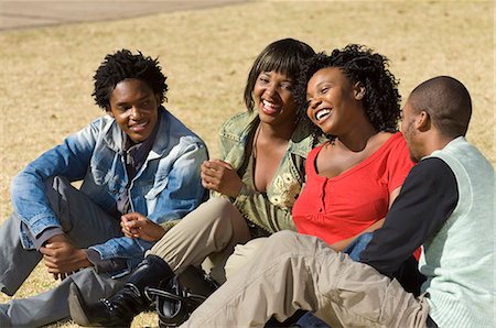 people in johannesburg - Friends sitting in a park laughing Stock Photo - Premium Royalty-Free, Code: 6110-07233652