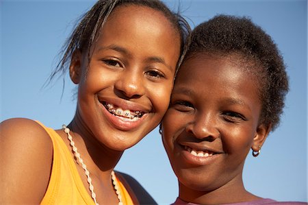 Two girls smiling, close-up Stock Photo - Premium Royalty-Free, Code: 6110-07233627