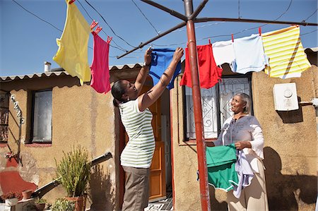 people in johannesburg - Woman hanging clothes on washing line Stock Photo - Premium Royalty-Free, Code: 6110-07233628