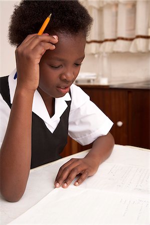 Girl studying, head in hands Stock Photo - Premium Royalty-Free, Code: 6110-07233631