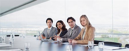 Portrait of confident business people at table in conference room Stock Photo - Premium Royalty-Free, Code: 6113-06497841