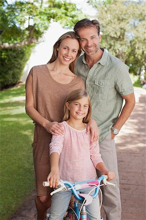 simsearch:6113-06498556,k - Portrait of smiling parents with daughter on bicycle Stock Photo - Premium Royalty-Free, Code: 6113-06498049