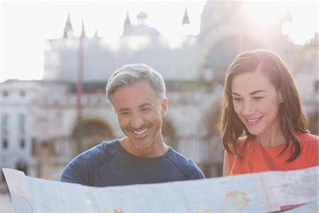 Smiling couple looking at map in Venice Stock Photo - Premium Royalty-Free, Code: 6113-06498089