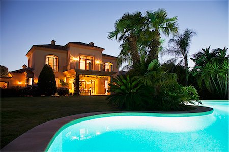 swimming pool night palm tree - Luxury swimming pool and villa illuminated at night Stock Photo - Premium Royalty-Free, Code: 6113-06498286