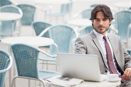 electronic mail - Businessman using laptop at sidewalk cafe Stock Photo - Premium Royalty-Free, Code: 6113-06498225