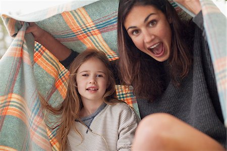 Enthusiastic mother and daughter under blanket Stock Photo - Premium Royalty-Free, Code: 6113-06498483
