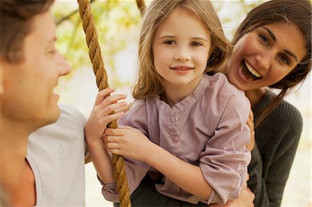 simsearch:6113-06498556,k - Portrait of happy family on swing Stock Photo - Premium Royalty-Free, Code: 6113-06498572