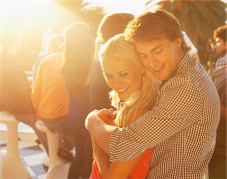 partier - Smiling couple hugging on sunny balcony Stock Photo - Premium Royalty-Free, Code: 6113-06498661