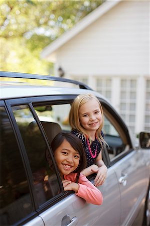 Girls smiling out car window Stock Photo - Premium Royalty-Free, Code: 6113-06498978