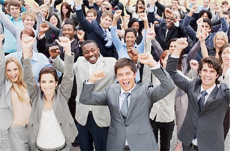 simsearch:6113-06499188,k - Portrait of business people cheering with arms raised in crowd Stock Photo - Premium Royalty-Free, Code: 6113-06499187