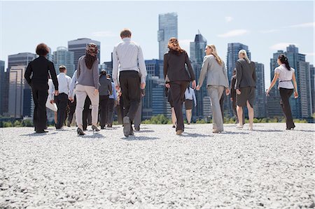 Business people walking toward city Stock Photo - Premium Royalty-Free, Code: 6113-06499196