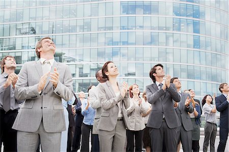 simsearch:6113-06499188,k - Smiling business people clapping and looking up Stock Photo - Premium Royalty-Free, Code: 6113-06499208