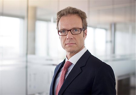 Businessman standing in office hallway Stock Photo - Premium Royalty-Free, Code: 6113-06625691