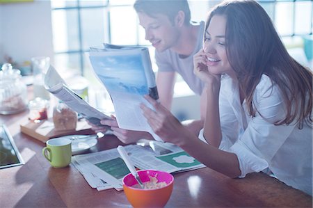 Couple reading magazines at breakfast Stock Photo - Premium Royalty-Free, Code: 6113-06625638