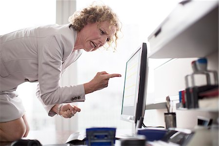 frustrated - Businesswoman yelling at computer in office Stock Photo - Premium Royalty-Free, Code: 6113-06625700