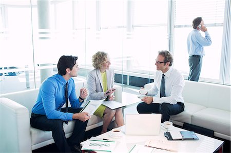 reporting - Business people talking in office lobby Stock Photo - Premium Royalty-Free, Code: 6113-06625822