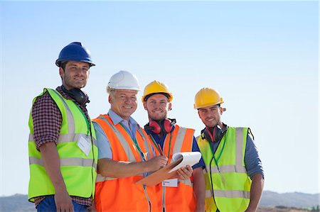 simsearch:614-06624685,k - Businessman and workers smiling on site Fotografie stock - Premium Royalty-Free, Codice: 6113-06625950