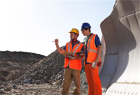 simsearch:6113-06625898,k - Workers talking by machinery in quarry Photographie de stock - Premium Libres de Droits, Code: 6113-06625986