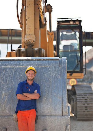 standing on a bridge - Worker standing by digger on site Stock Photo - Premium Royalty-Free, Code: 6113-06625993