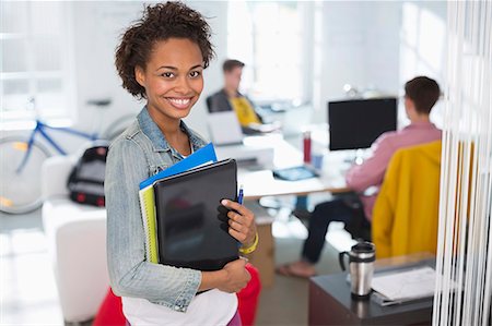 starting position - Businesswoman carrying laptop in office Stock Photo - Premium Royalty-Free, Code: 6113-06626088