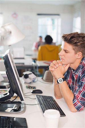 entrepreneur focus - Businessman working at computer at desk Stock Photo - Premium Royalty-Free, Code: 6113-06626033