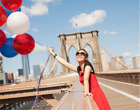 standing on a bridge - Woman with bunch of balloons on urban bridge Stock Photo - Premium Royalty-Free, Code: 6113-06626169