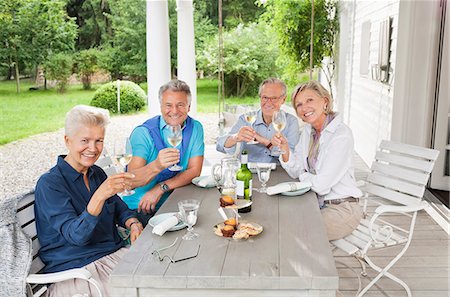 simsearch:6113-07242109,k - Friends toasting each other with wine at table Stock Photo - Premium Royalty-Free, Code: 6113-06626397