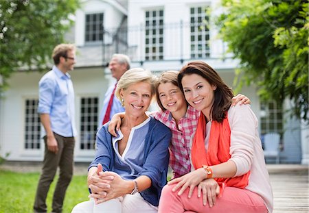 senior family sitting - Family smiling together outside house Stock Photo - Premium Royalty-Free, Code: 6113-06626300