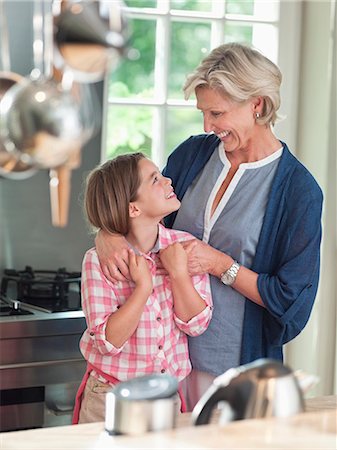 simsearch:649-03858052,k - Woman and granddaughter smiling in kitchen Stock Photo - Premium Royalty-Free, Code: 6113-06626408