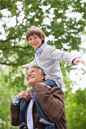 Man carrying grandson on shoulders outdoors Stock Photo - Premium Royalty-Free, Code: 6113-06626410