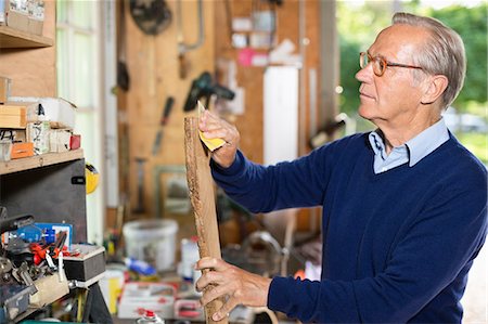 domestic life - Man sanding wood in garage Stock Photo - Premium Royalty-Free, Code: 6113-06626415